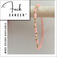 Load image into Gallery viewer, Pink beaded bracelet with gold accents on a wooden stick, with text 'Fuck Cancer' and 'More colors available' on a white background.