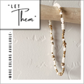 Load image into Gallery viewer, Beaded bracelet with gold and white beads on a textured surface, with text overlay.