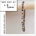 Load image into Gallery viewer, Multicolored beaded bracelet on a wooden stick with 'One Day at a Time' text and 'More Colors Available' note.