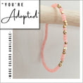 Load image into Gallery viewer, Pink beaded bracelet with gold accents on a light gray background, featuring text 'You're Adopted' and 'More colors available'.

