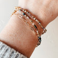 Load image into Gallery viewer, Close-up of a wrist wearing multiple bracelets on a neutral background
